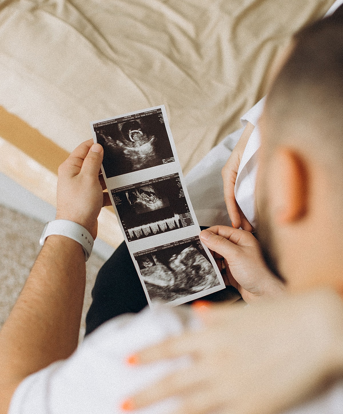 Expecting parents reviewing ultrasound images together.