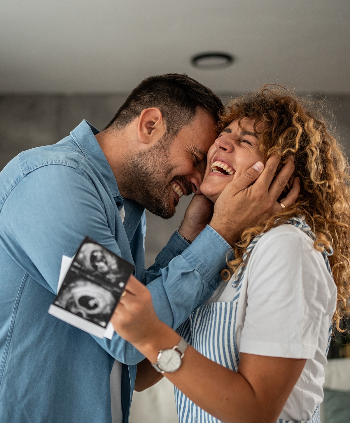 Couple joyfully sharing pregnancy announcement moment.