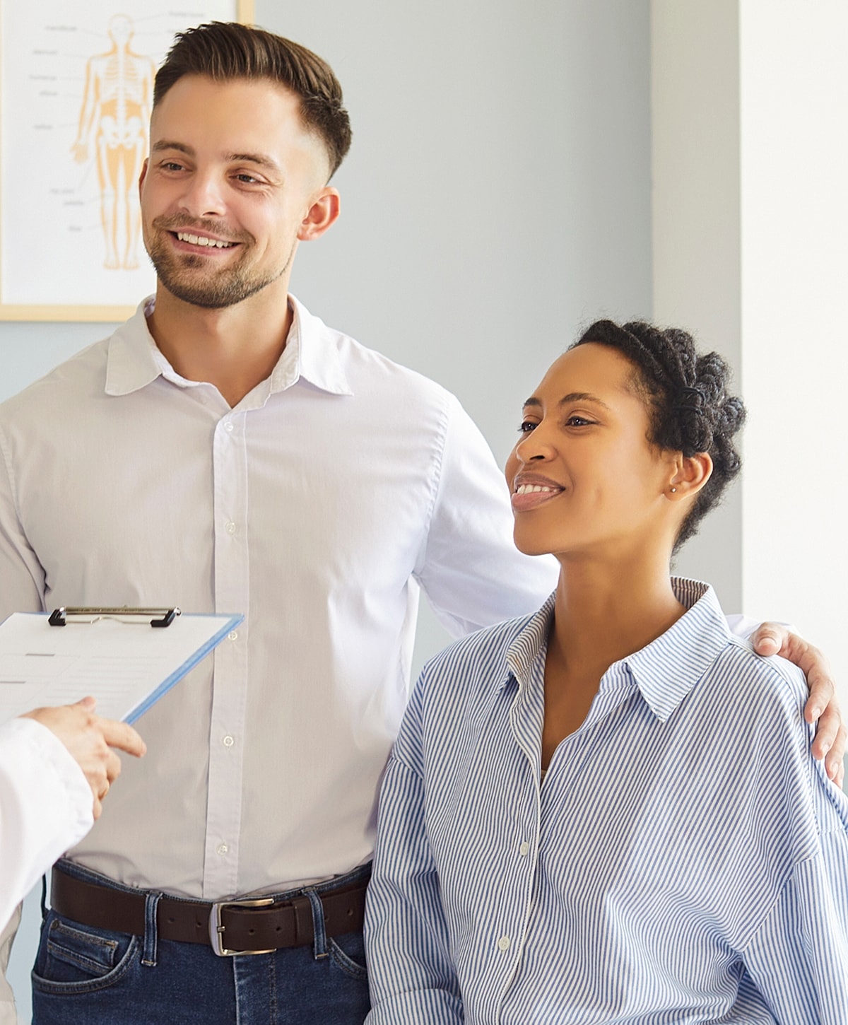 Smiling adults in a medical consultation setting.