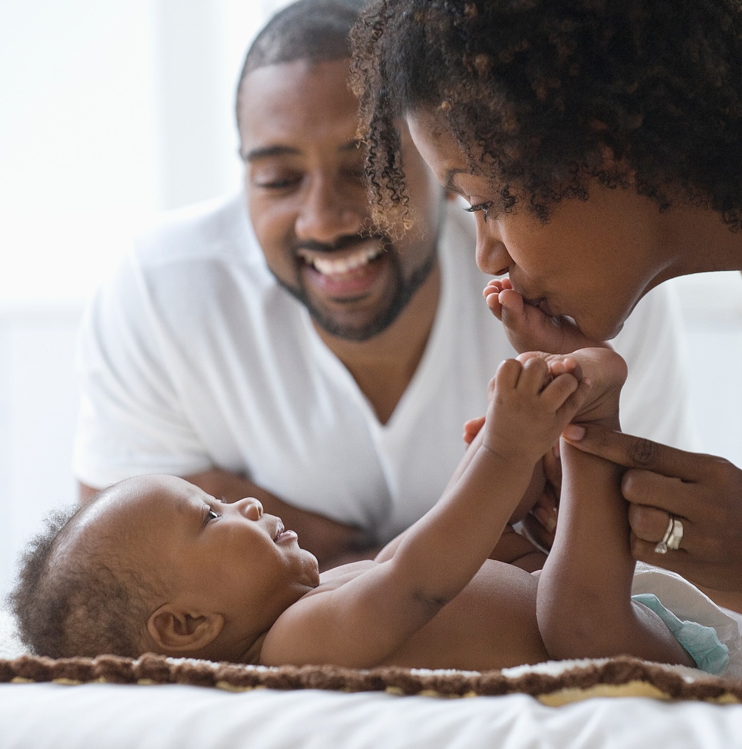 Family playing together with their joyful baby.