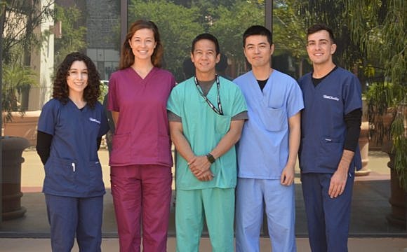 Group of healthcare professionals in scrubs.