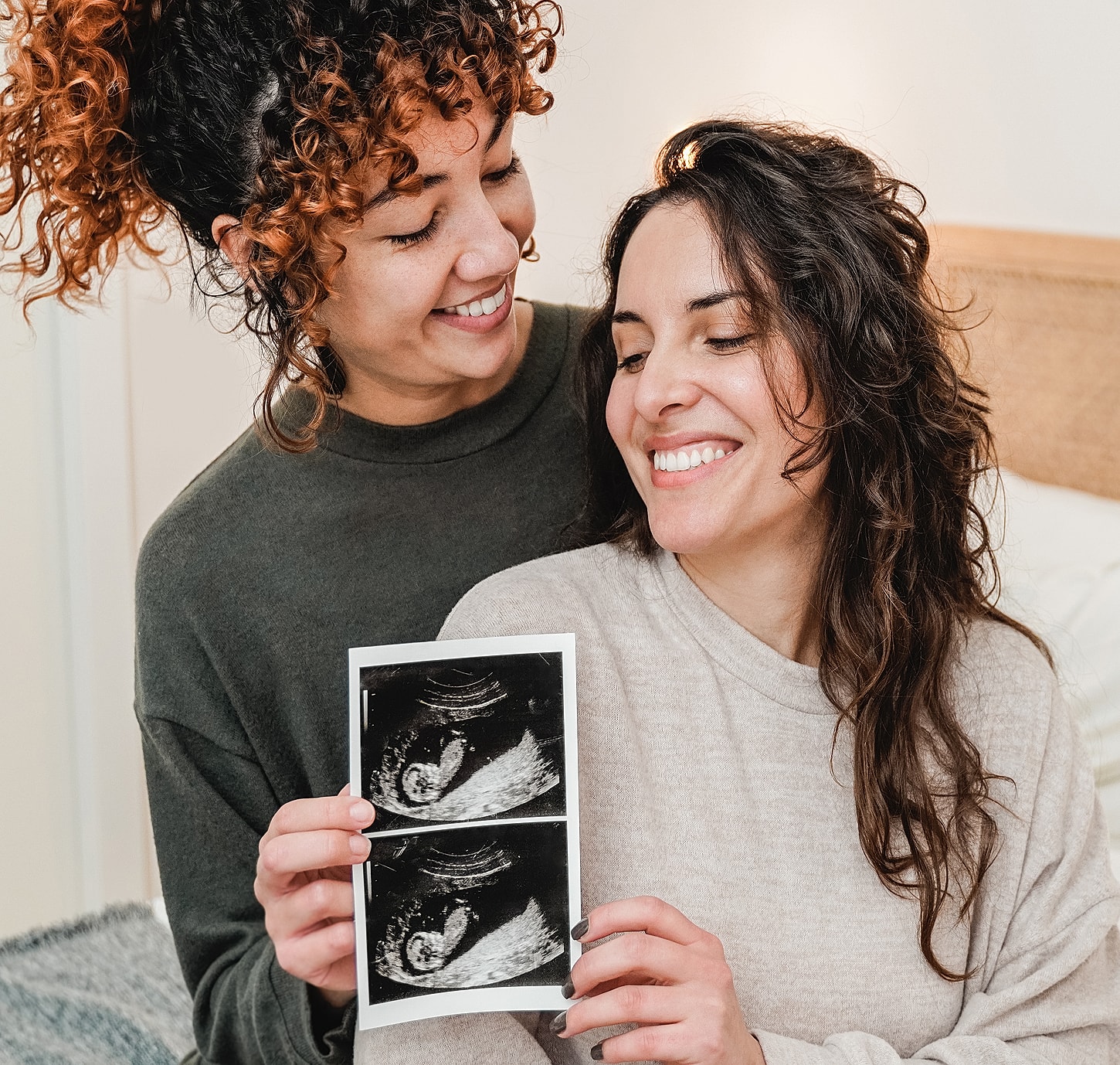 Couple joyfully sharing ultrasound photo together.