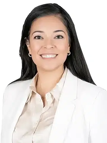 Professional woman smiling in business attire.