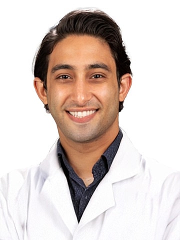 Smiling healthcare professional in lab coat.