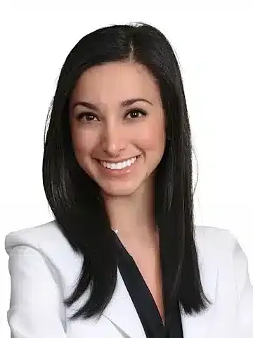 Professional woman smiling in a white blazer.