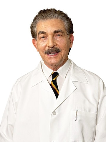 Smiling doctor in a white coat and tie.