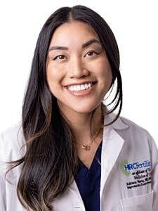 Smiling healthcare professional in lab coat.