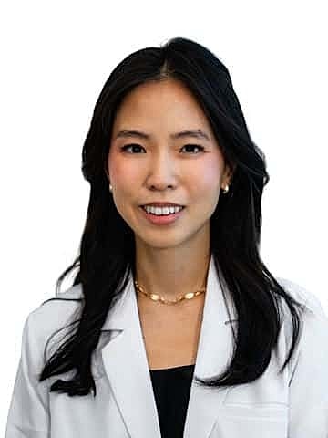 Smiling female doctor in a white lab coat.