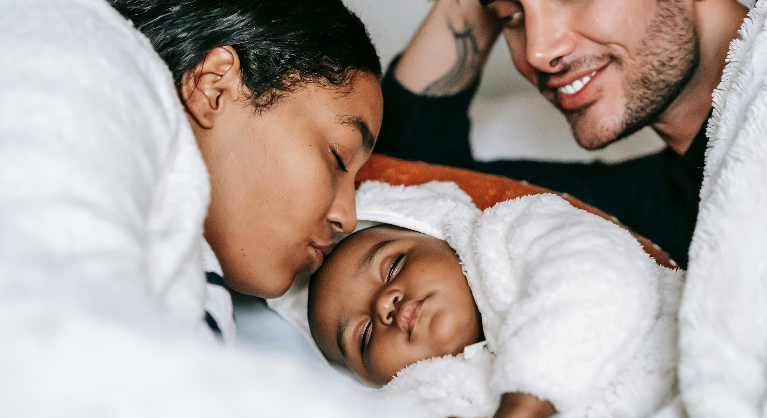 Family lying together, enjoying peaceful moments.