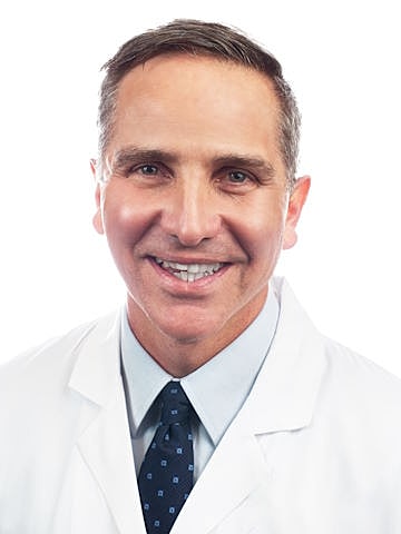 Smiling doctor in white coat.