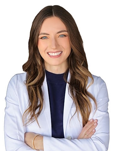 Smiling woman in a white lab coat.