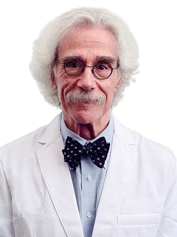 Elderly man in lab coat with bow tie.