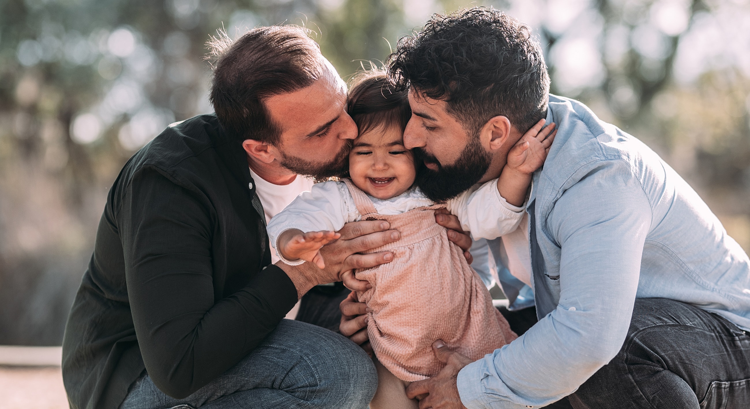 Happy family sharing affectionate moments outdoors.