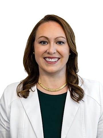 Smiling professional woman in a white coat