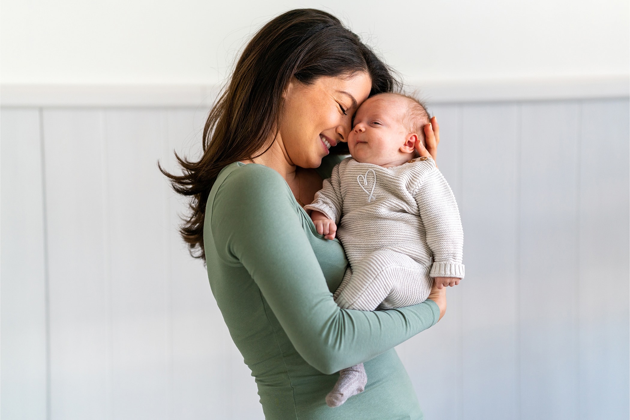 Mother and baby sharing a joyful moment.