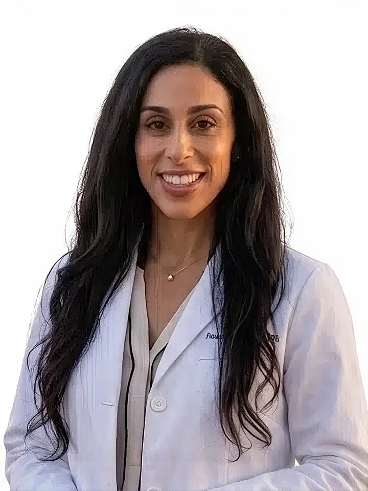 Smiling woman in a doctor's coat.
