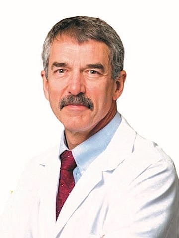 Man in white coat with a mustache.