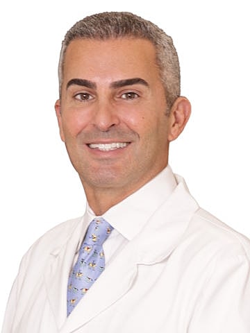 Smiling doctor in a white coat and tie