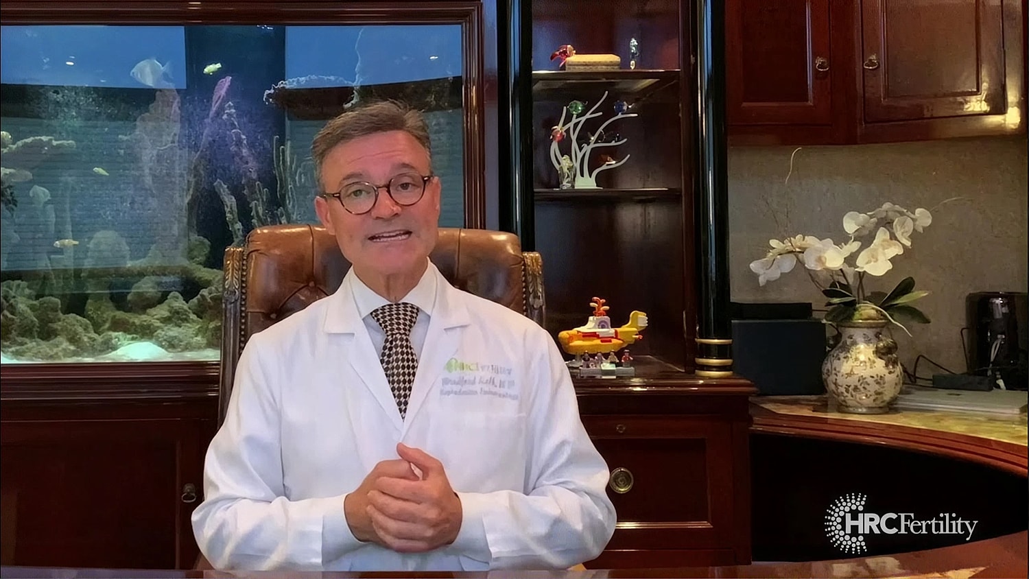 Medical professional speaking in an office setting.