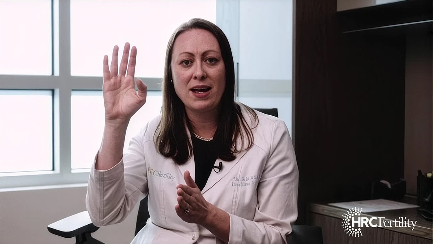 Doctor explaining fertility concepts in consultation setting.